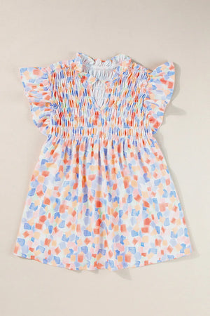 Smocked bodice blouse with brushstroke print and flutter sleeves in pastel blue and sherbet tones.