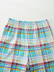 Baby shorts with elastic waistband and colorful plaid pattern in blue, yellow, and red cotton.