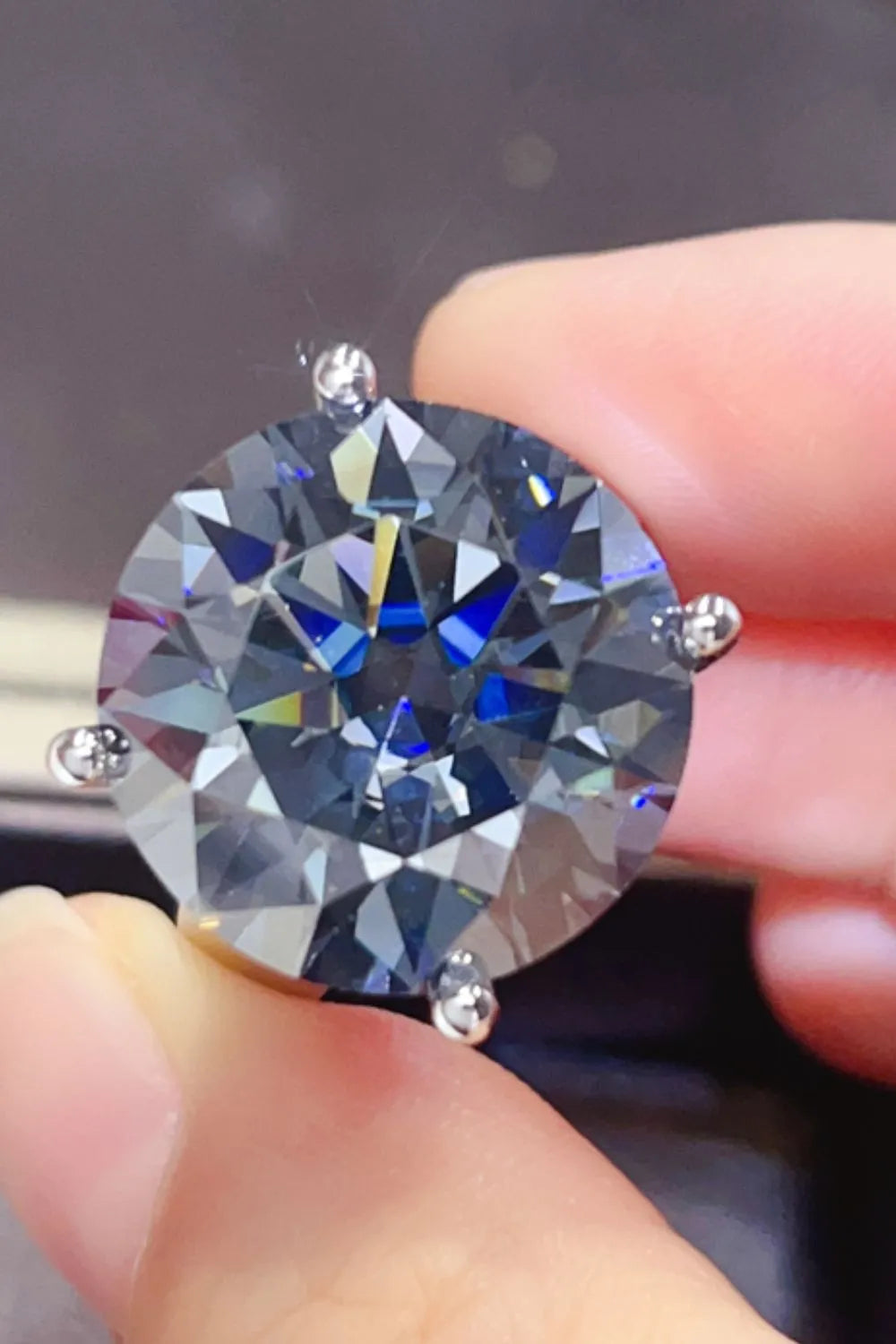 Round moissanite cocktail ring in royal blue with prong setting.