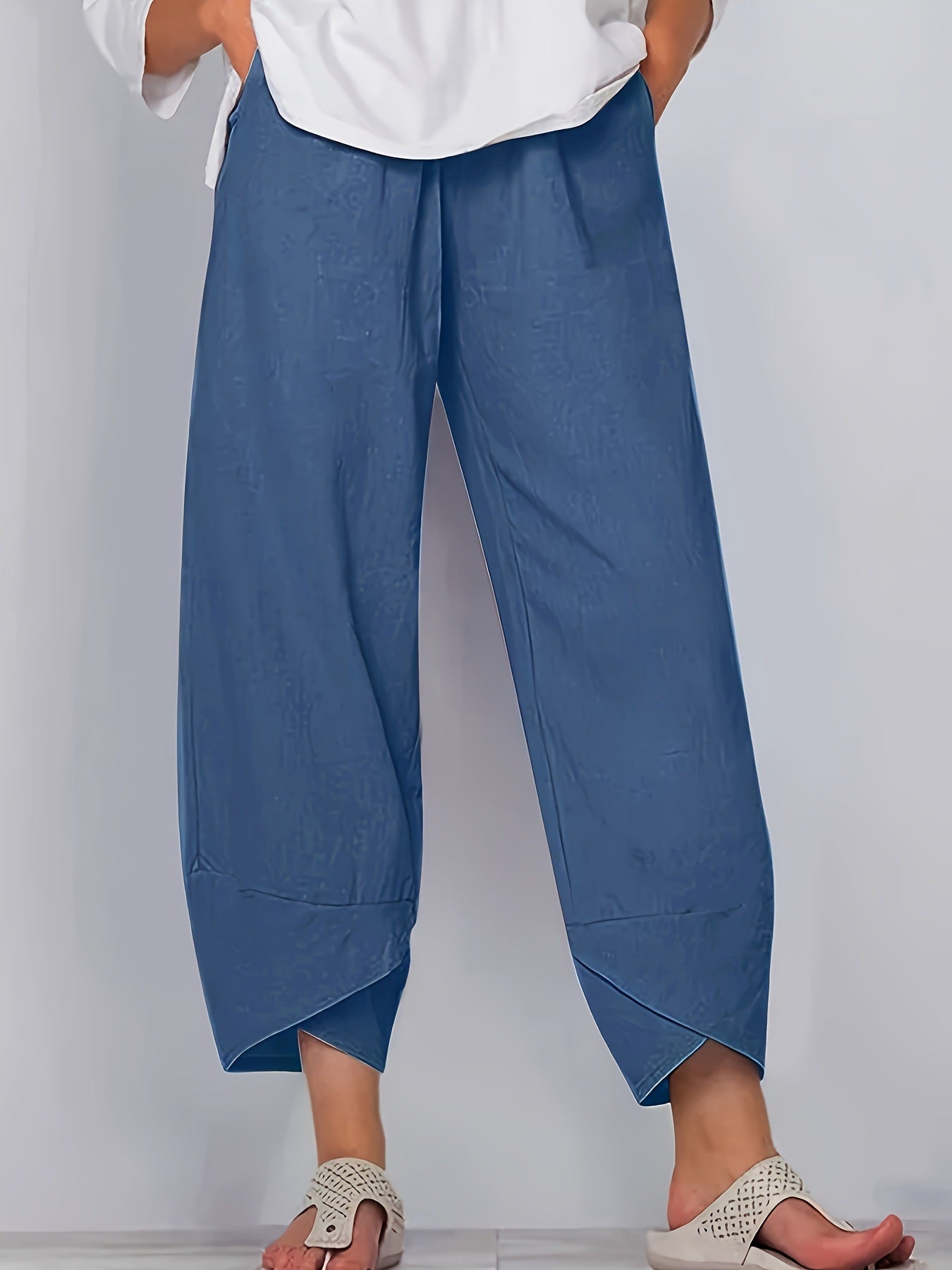 Relaxed fit wide-leg pants in Peacock Blue with pockets and asymmetrical hem.