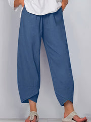 Relaxed fit wide-leg pants in Peacock Blue with pockets and asymmetrical hem.