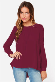 Burgundy long sleeve blouse with a fluid silhouette and pleated back detail.