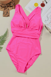 Hot pink one-piece swimsuit with crisscross plunge neckline and ruched waist detail