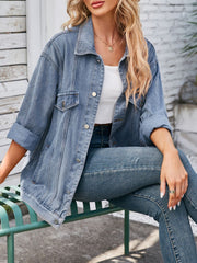 Oversized denim trucker jacket in dusty blue with rolled sleeves and button details.