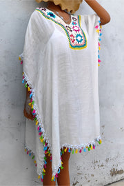 White kaftan dress with colorful crochet yoke and tassel trim