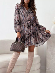 Delicate floral tie-waist mini dress with button-down front and tiered skirt.