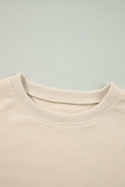Cream sweatshirt with ribbed crew neck and visible stitching detail.