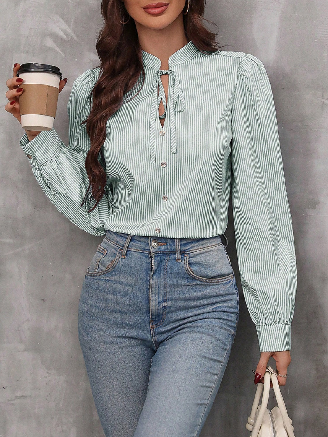 Light green striped blouse with puffed sleeves and keyhole neckline detail.