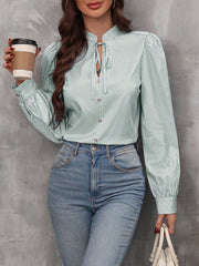 Light green striped blouse with puffed sleeves and keyhole neckline detail.