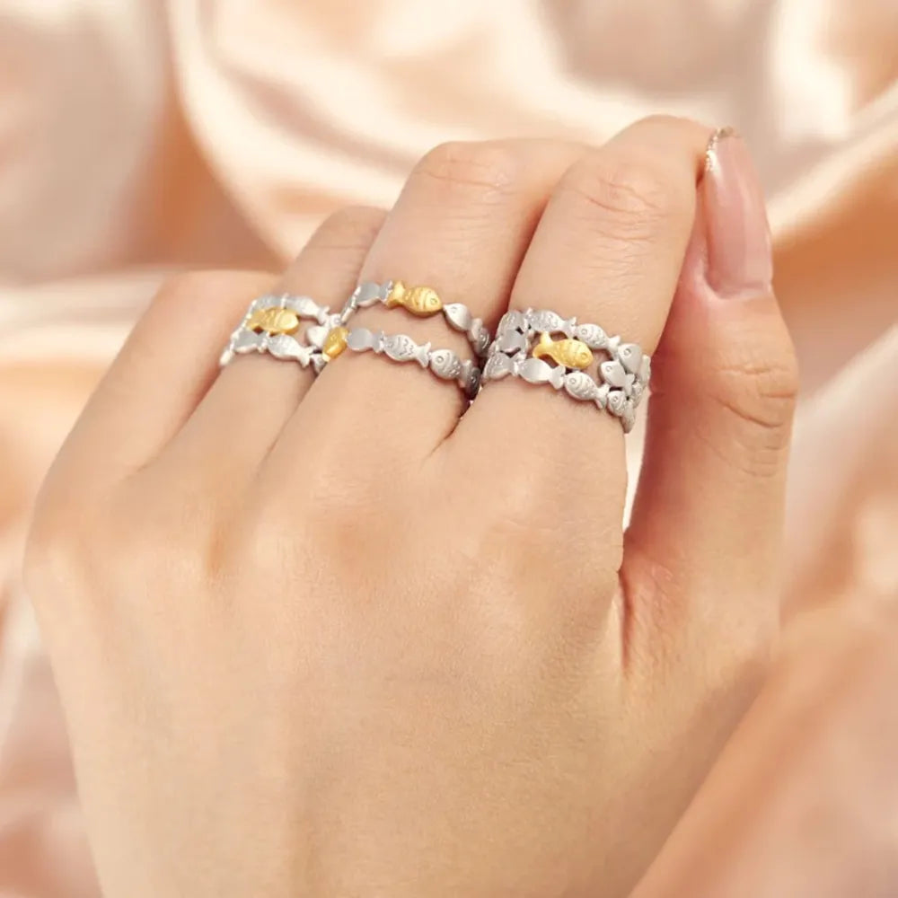Adjustable silver rings with gold fish accents, Style A and Style B shown on hand.