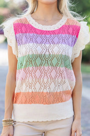 Rainbow crochet blouse with flutter sleeves and diamond pattern in stripe colors.