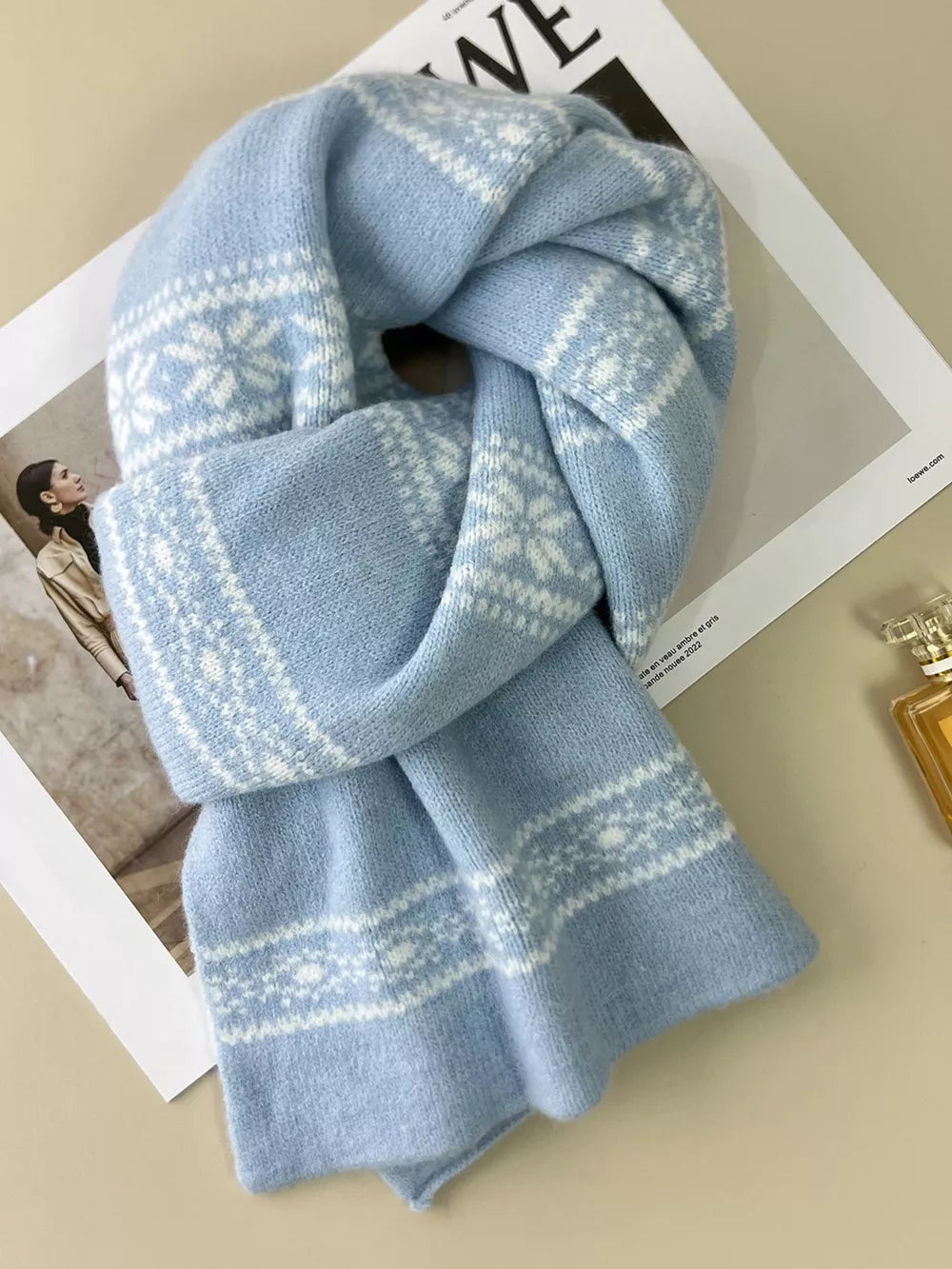 Sky blue wool blend scarf with white snowflake pattern, reversible design.