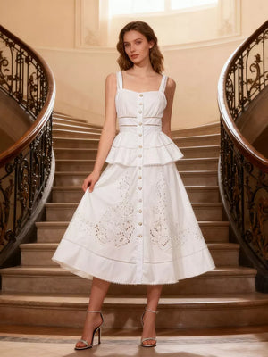 White eyelet embroidered midi dress with button front, tiered skirt, and cutout details.