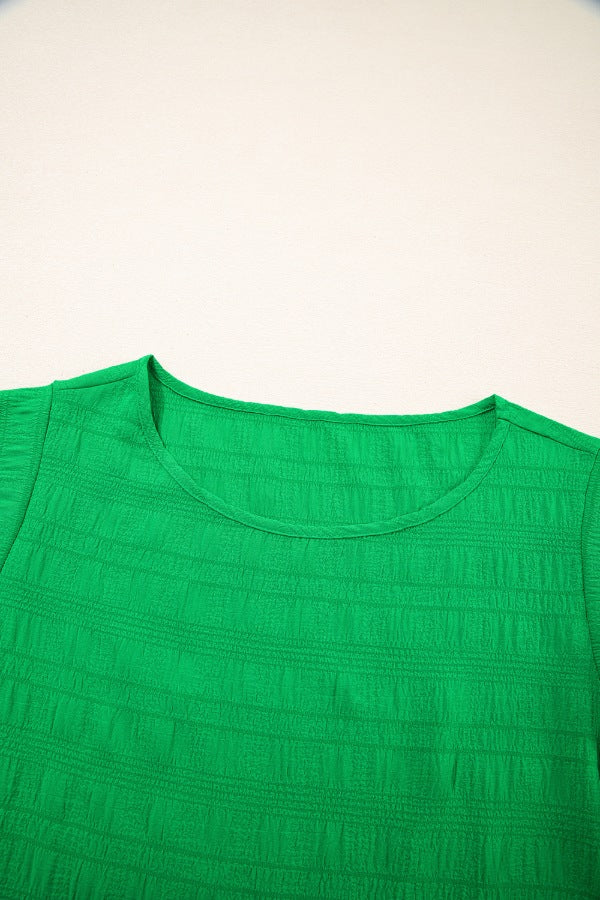 Green crew neck blouse with textured fabric and ruffle sleeves