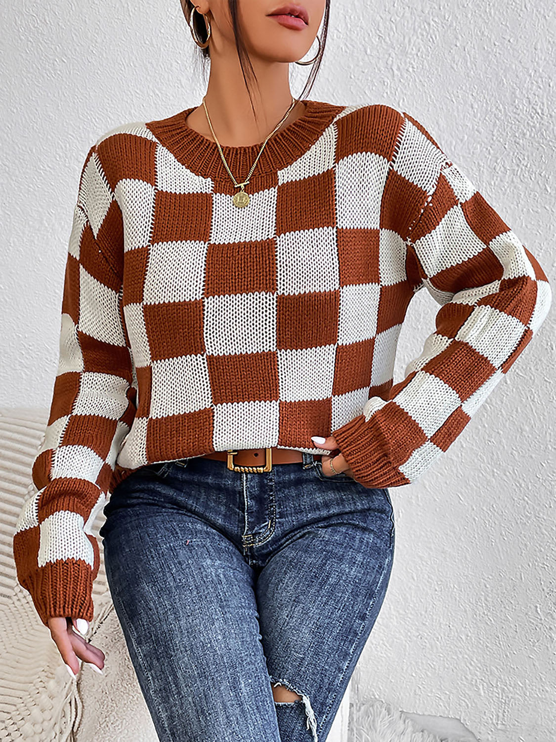 Checkerboard knit crewneck pullover sweater in chestnut and white acrylic with long sleeves.