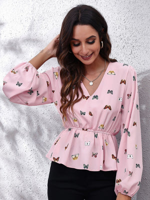 Dusty pink peplum blouse with butterfly print, V-neck, gathered waist, and bishop sleeves.