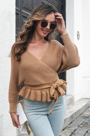 Camel knit wrap sweater with ruffled hem and tie waist, featuring a V-neck and balloon sleeves.