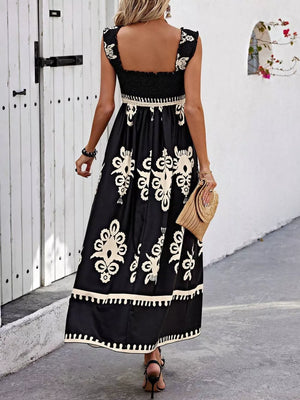 Black smocked square neck maxi dress with cream floral print and ruffled sleeves.