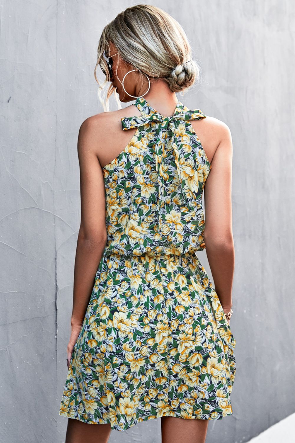 Yellow floral halter neck mini dress with tie back detail