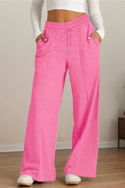 Fuchsia pink seamed palazzo lounge trousers with drawstring waist and pockets.