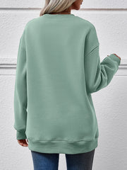 Sage green crewneck sweatshirt with ribbed cuffs and hem.