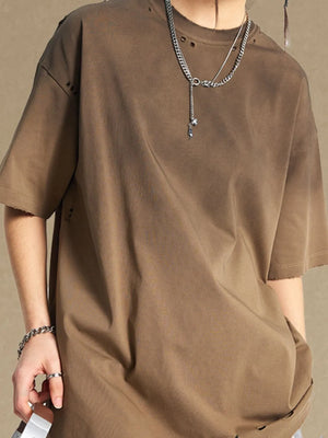 Taupe oversized t-shirt with distressed neckline and hem, short sleeves.