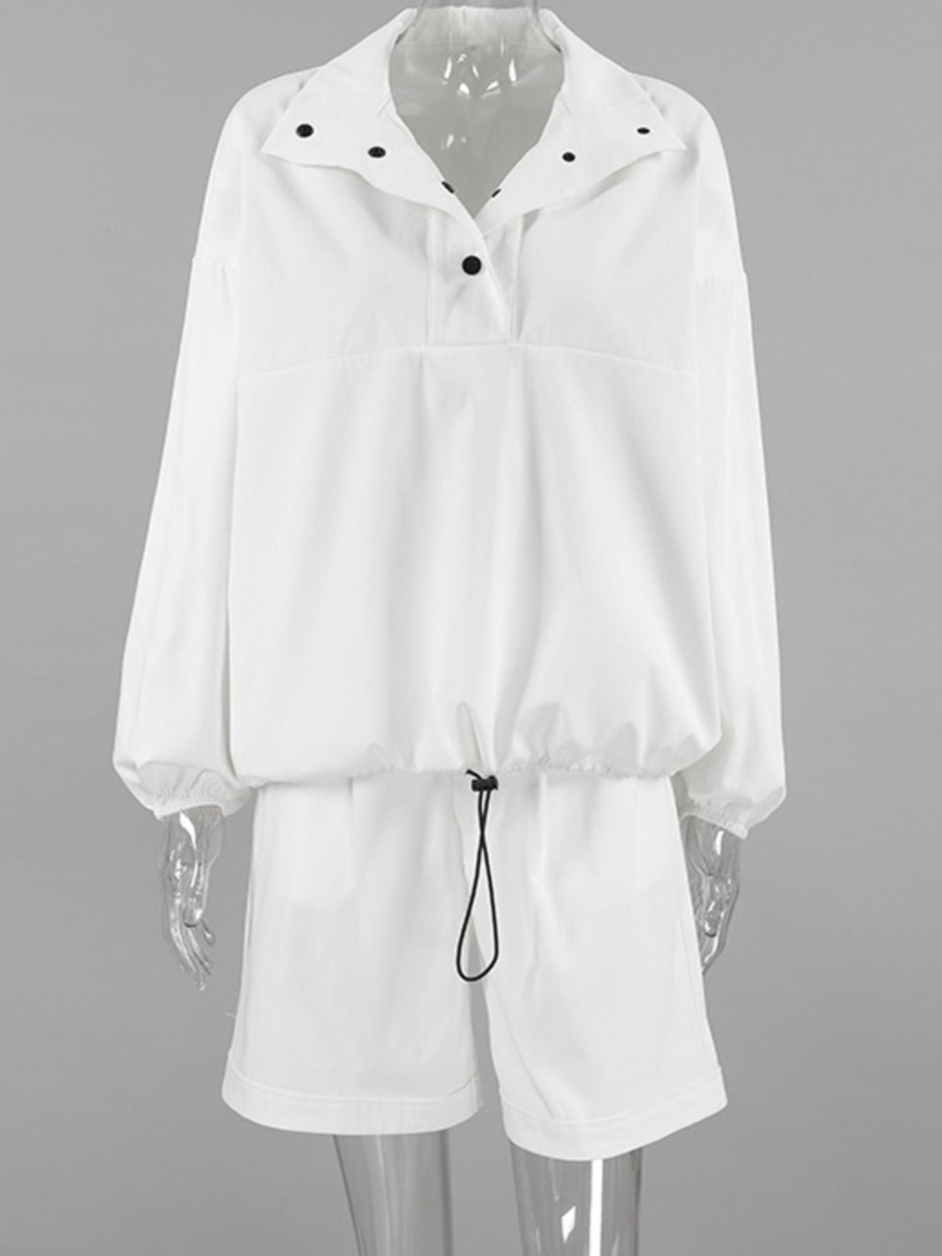 White two-piece set with snap details on collar and drawstring waist.
