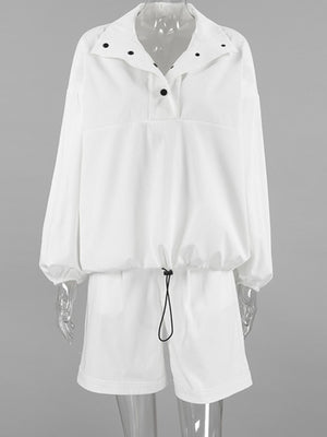 White two-piece set with snap details on collar and drawstring waist.