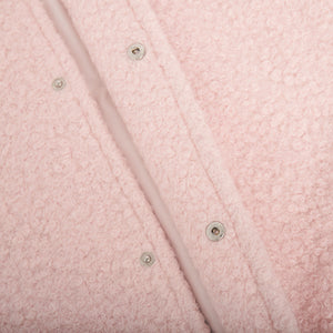 Blush pink textured bouclé bomber jacket with rounded neck and snap closures.