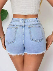 Light wash denim shorts with frayed hem and distressed details.