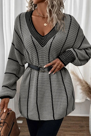 Gray knit oversized V-neck dress with black vertical stripes and black trim.
