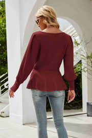 Burgundy ribbed knit peplum top with voluminous sleeves and a scoop neckline.
