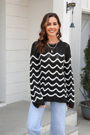 Black openwork sweater with white wavy stripes and crew neck.