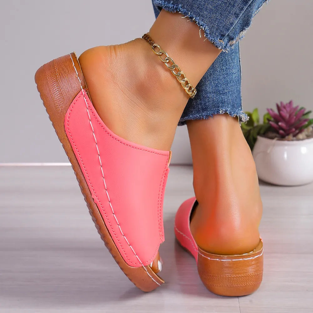 Strawberry stitched edge wedge mules with peep toe and wooden heel.