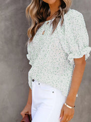 Maternity blouse in green floral print polyester with smocked bodice and ruffle sleeves.