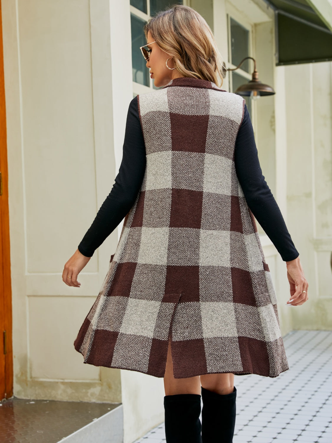 Geometric knit duster vest with checkered pattern in brown and tan, sleeveless, collared, and midi length.