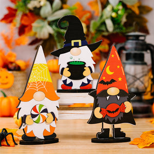 Halloween gnome figurines: candy corn, cauldron, and vampire styles.