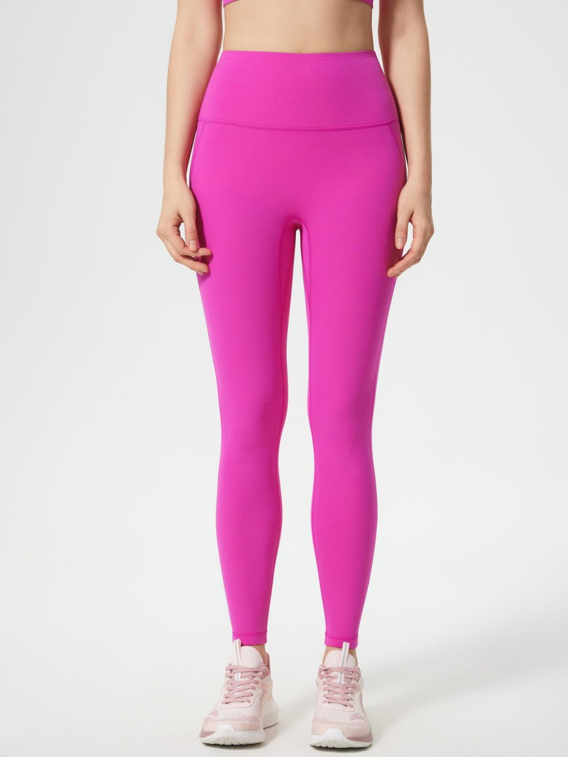 Fuchsia pink high-waisted sculpted contour leggings with pocket detail.