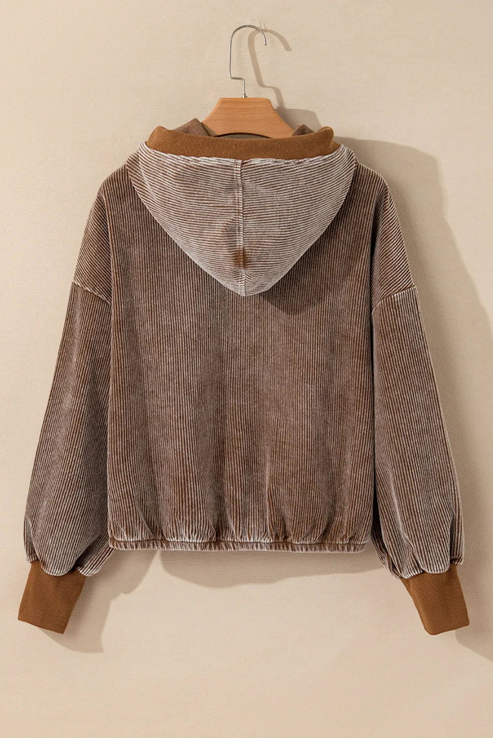 Brown corduroy hoodie with voluminous sleeves and elastic cuffs.