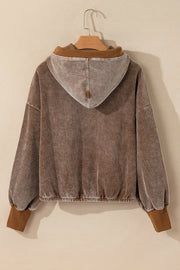 Brown corduroy hoodie with voluminous sleeves and elastic cuffs.