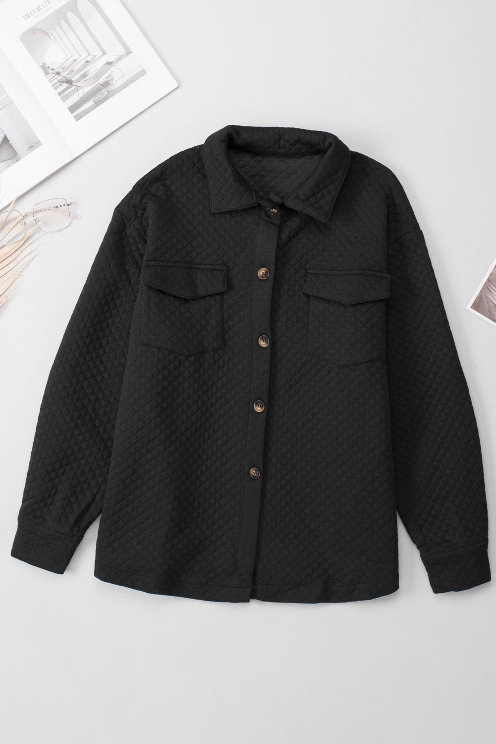 Black quilted overshirt with patch pockets and button front.