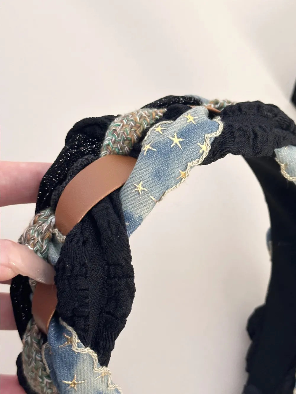 Black braided headband with denim starburst and leatherette accents