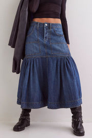 Denim midi skirt in dark wash with flounce hem, patch pockets, and button fly.