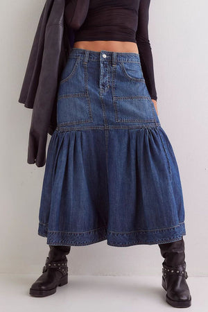 Denim midi skirt in dark wash with flounce hem, patch pockets, and button fly.