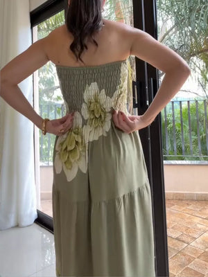 Strapless maxi dress in olive green with smocked bodice, floral print, and tiered skirt.