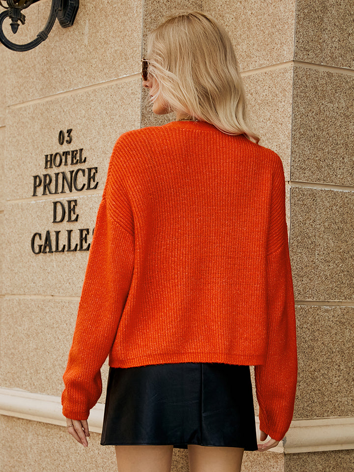 Orange-Red textured button-down knit cardigan with ribbed detail.