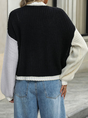 Colorblock trim knit cardigan in black with gray and cream sleeves.