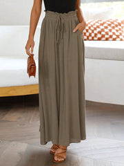 Gathered waist palazzo pants in mocha with drawstring and pockets, styled with sandals.
