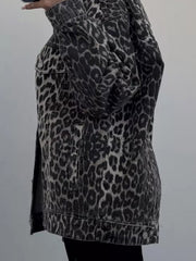 Oversized denim jacket in leopard print with button closure and chest pockets.