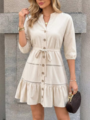 V-neck buttoned cotton mini dress with tie waist and ruffled hem.